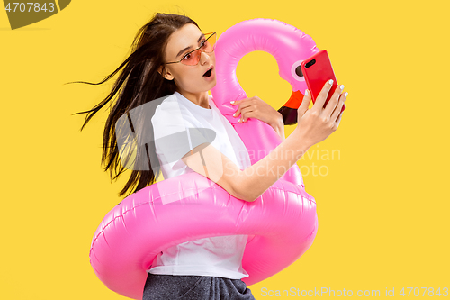 Image of Portrait of beautiful woman isolated on yellow studio background