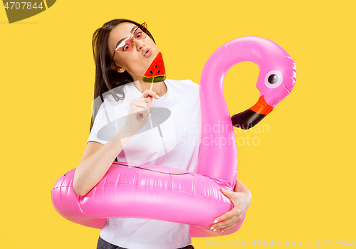 Image of Portrait of beautiful woman isolated on yellow studio background