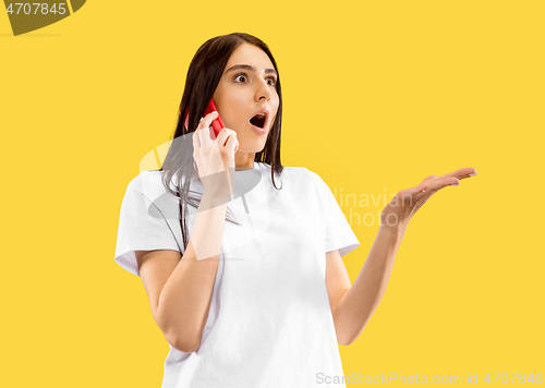 Image of Portrait of beautiful woman isolated on yellow studio background