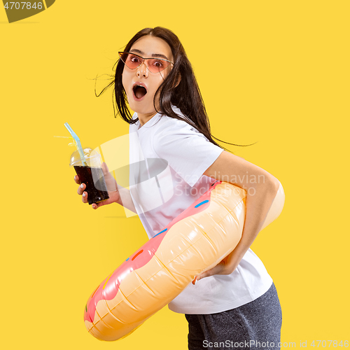 Image of Portrait of beautiful woman isolated on yellow studio background