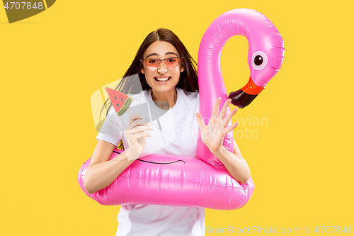 Image of Portrait of beautiful woman isolated on yellow studio background