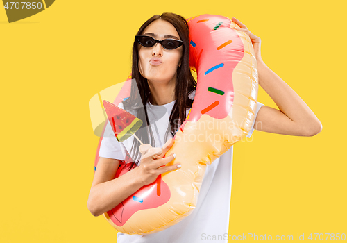 Image of Portrait of beautiful woman isolated on yellow studio background