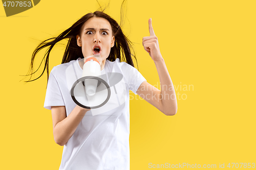 Image of Portrait of beautiful woman isolated on yellow studio background