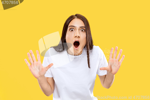 Image of Portrait of beautiful woman isolated on yellow studio background