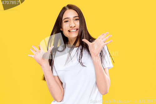 Image of Portrait of beautiful woman isolated on yellow studio background