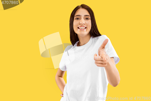 Image of Portrait of beautiful woman isolated on yellow studio background