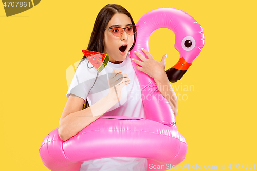 Image of Portrait of beautiful woman isolated on yellow studio background