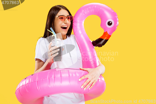 Image of Portrait of beautiful woman isolated on yellow studio background