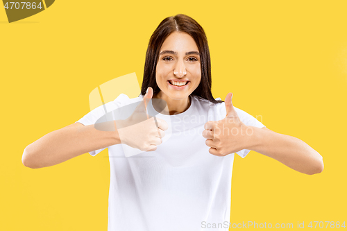 Image of Portrait of beautiful woman isolated on yellow studio background