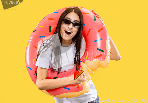 Image of Portrait of beautiful woman isolated on yellow studio background