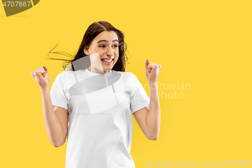 Image of Portrait of beautiful woman isolated on yellow studio background