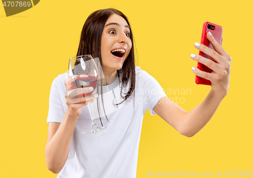 Image of Portrait of beautiful woman isolated on yellow studio background