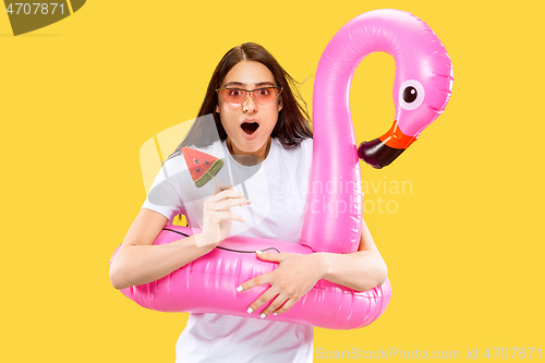 Image of Portrait of beautiful woman isolated on yellow studio background