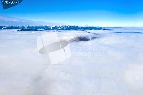 Image of Flying drone over low clouds