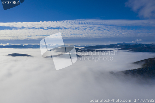 Image of Low clouds in valley, aerial morning scene