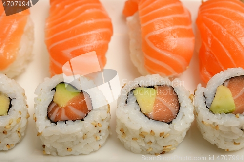 Image of sushi with salmon and rolls on a plate