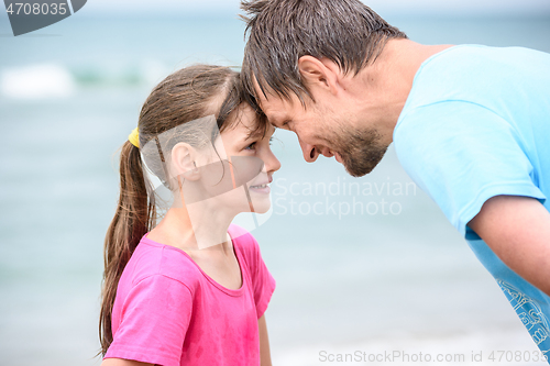 Image of Happy dad and daughter are butting heads cheerfully