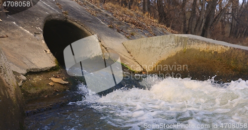 Image of Large sewage tunnel with filth flowing out