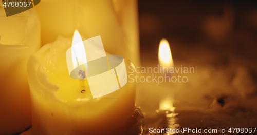 Image of Candles glowing against dark background