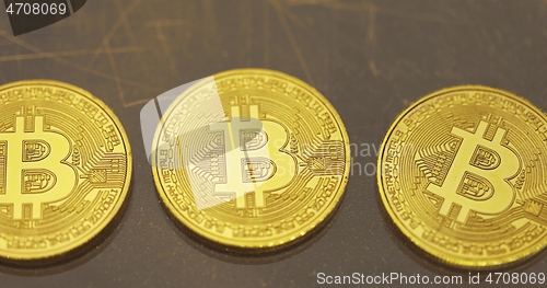 Image of Physical shiny bitcoin agains dark background