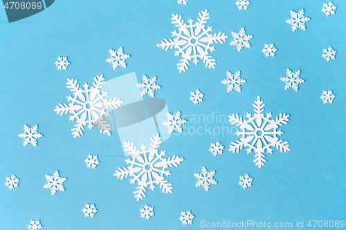 Image of white snowflake decorations on blue background