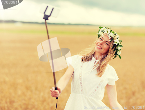 Image of happy young woman taking selfie by smartphone