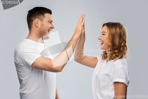 Image of happy couple making high five gesture