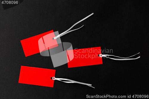 Image of three red sale tags on black background