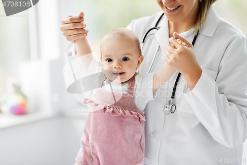 Image of female pediatrician doctor with baby at clinic