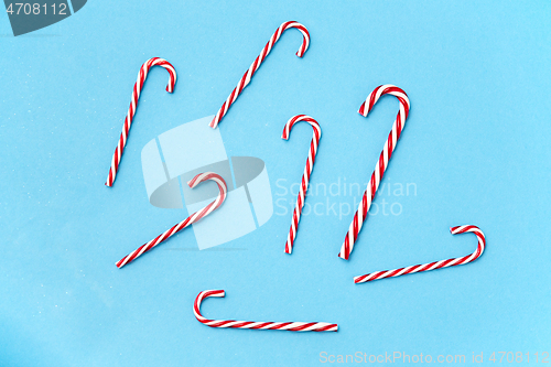 Image of candy cane decorations on blue background