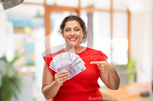 Image of happy woman showing euro money banknotes