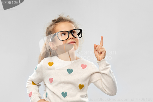Image of portrait of girl in glasses pointing finger up
