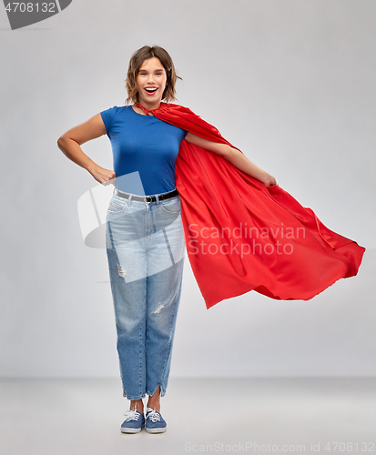 Image of happy woman in red superhero cape