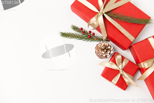 Image of christmas gifts and fir branches with pine cones