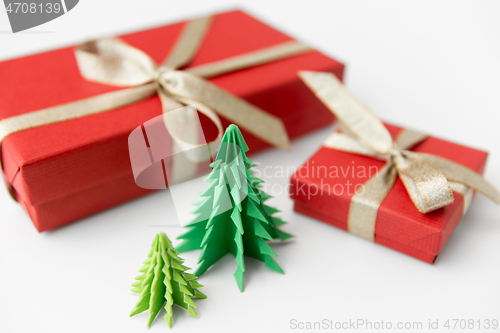 Image of gift boxes and christmas trees on white background