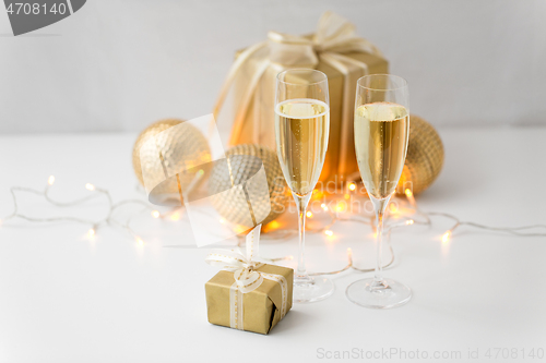 Image of glasses of champagne and christmas gifts