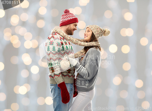 Image of happy couple at christmas ugly sweater party