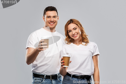 Image of portrait of happy couple with takeaway coffee cups