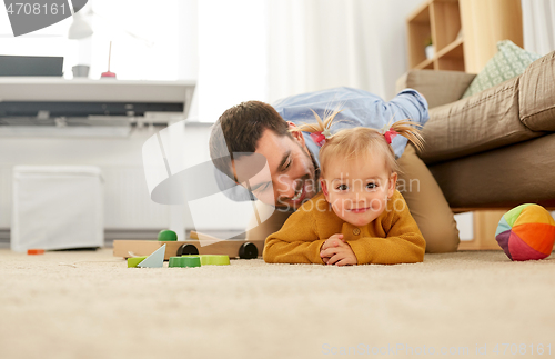 Image of happy father with baby daughter playing at home