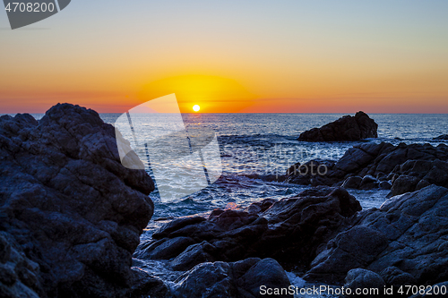 Image of Sunset on the rocky shore. 