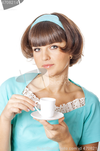 Image of Portrait of young woman in blak dress enjoying a cup of coffee.