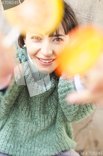 Image of Portrait of pretty young happy woman posing with sweet lollipops