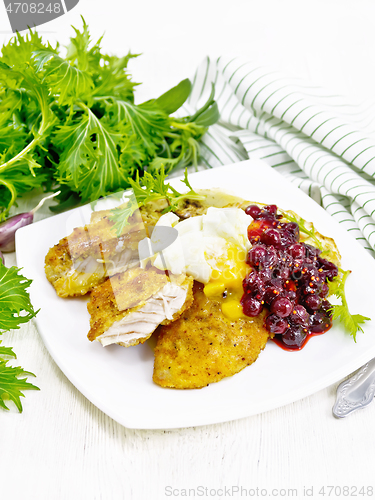 Image of Turkey breast with cranberry sauce on wooden board