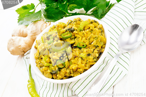 Image of Kitchari with celery in bowl on wooden board