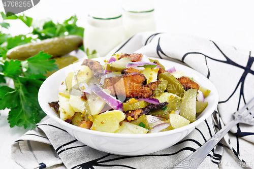 Image of Salad potato with bacon and cucumber in plate on white board