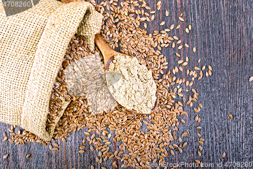 Image of Flour flax in spoon with seeds on board top