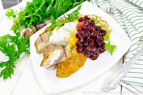 Image of Turkey breast with cranberry sauce on table