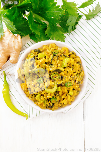 Image of Kitchari with celery in bowl on board top