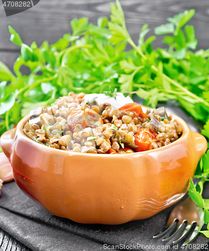 Image of Lentils with eggplant and tomatoes in bowl on towel