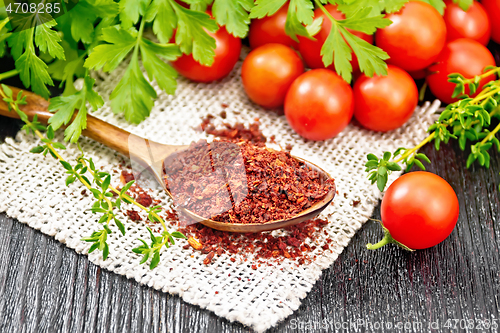 Image of Tomatoes dried in spoon on dark board